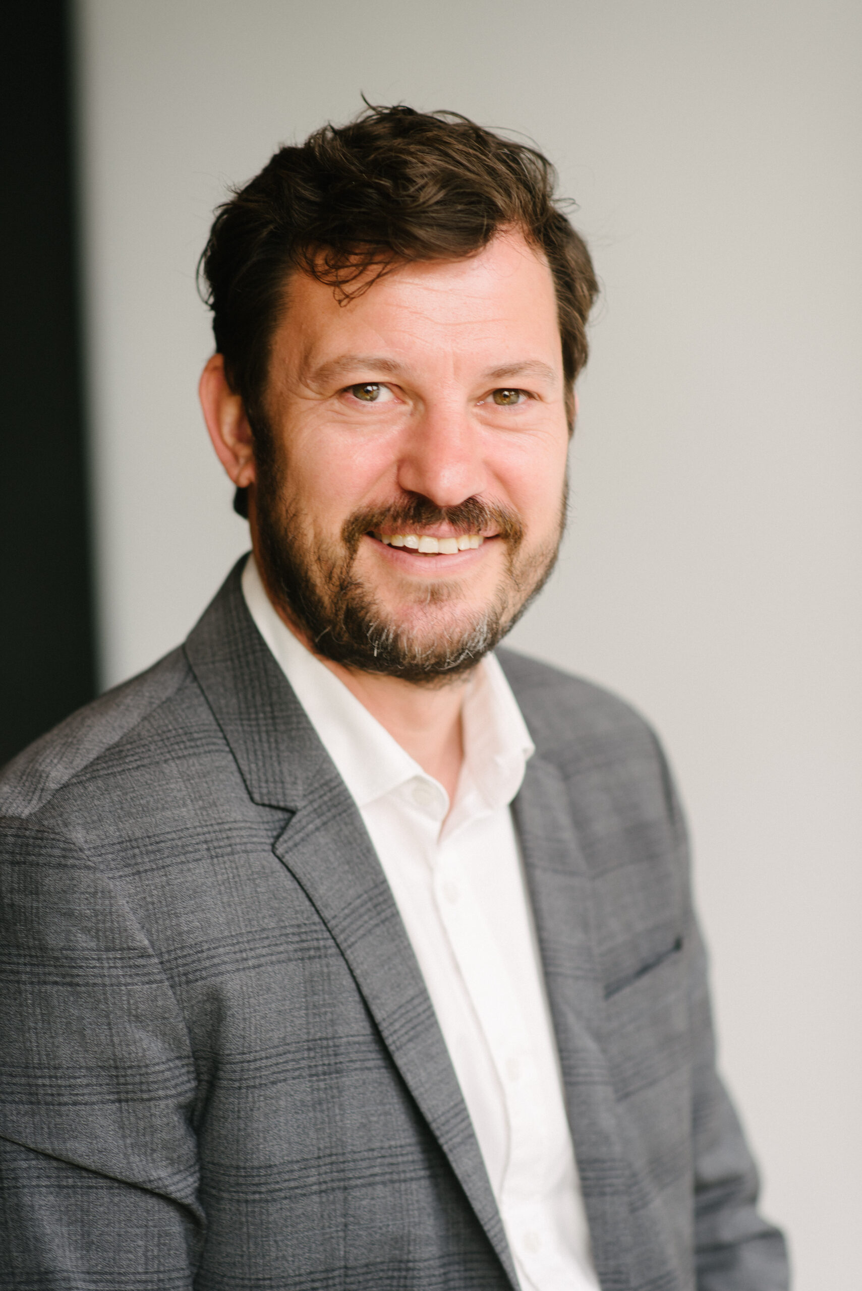 Ben Larkin, CTO of Propp, sitting in a grey suit and a white shirt.