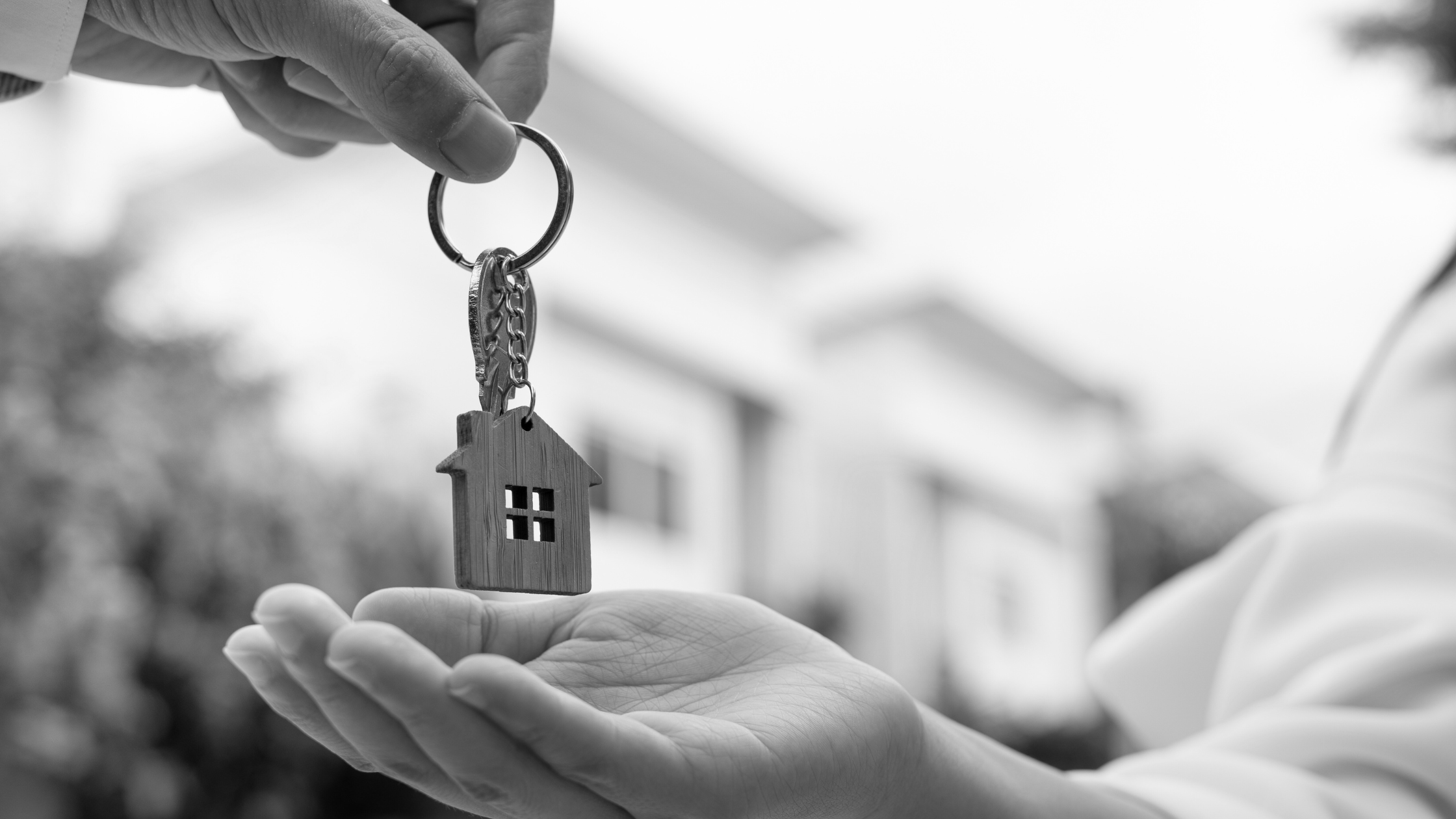 A person being handed over some house keys